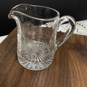 Clear glass with floral designs serving pitcher